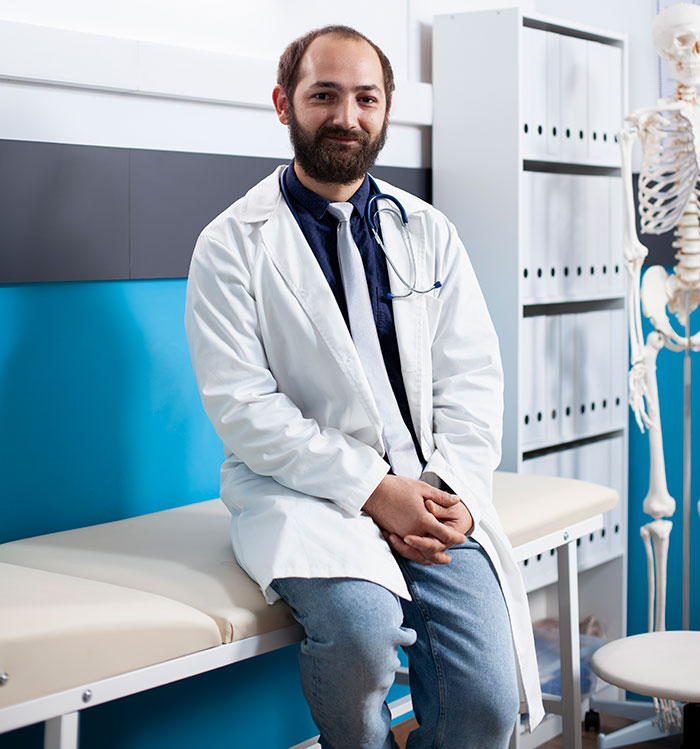 Male doctor sitting in a clinic with stethoscope, representing heartbreaking medical conditions that can't be cured.