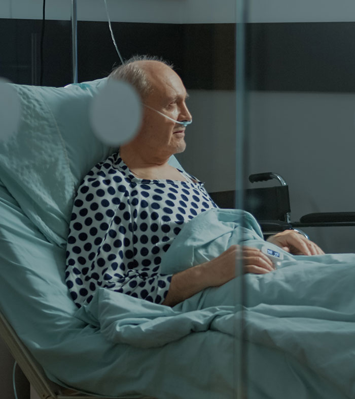 Elderly man in hospital bed with oxygen tube, representing heartbreaking medical conditions that can’t be cured.