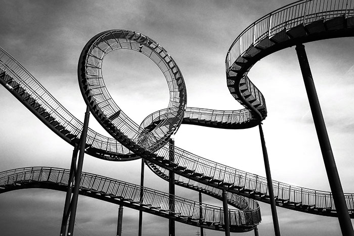 A complex looping roller coaster structure symbolizing lucky escapes from dangerous situations.