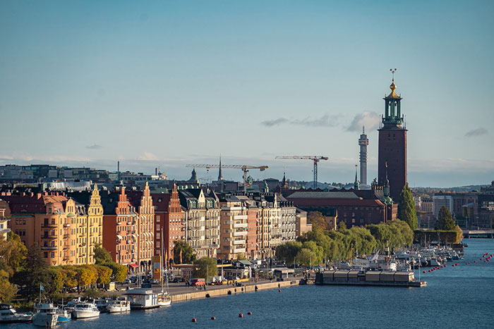 Scenic waterfront cityscape with historic buildings and boats, illustrating lucky times people got out of dangerous situations.