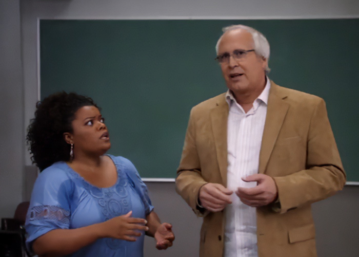 Chevy Chase and Community actress in a classroom scene amid Chevy Chase N-Word scandal discussion and new documentary response.
