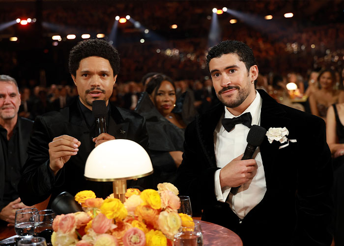 Two men in tuxedos holding microphones at the 2026 Grammy Awards during notable cringe moments.