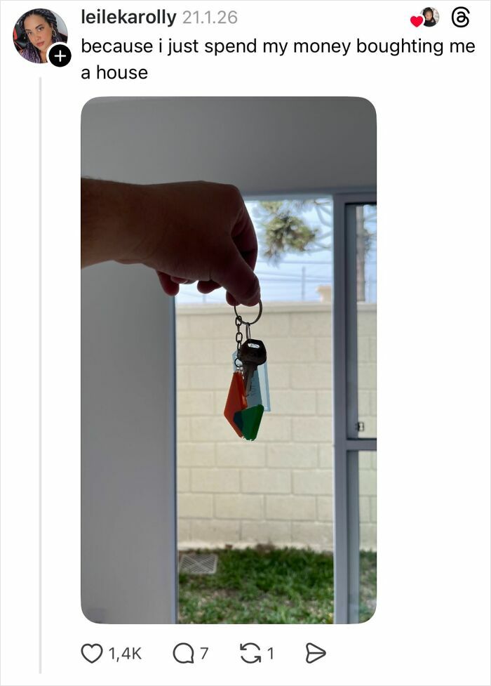 Hand holding house keys inside a home, illustrating a savage reply about spending money on buying a house instead of nails.