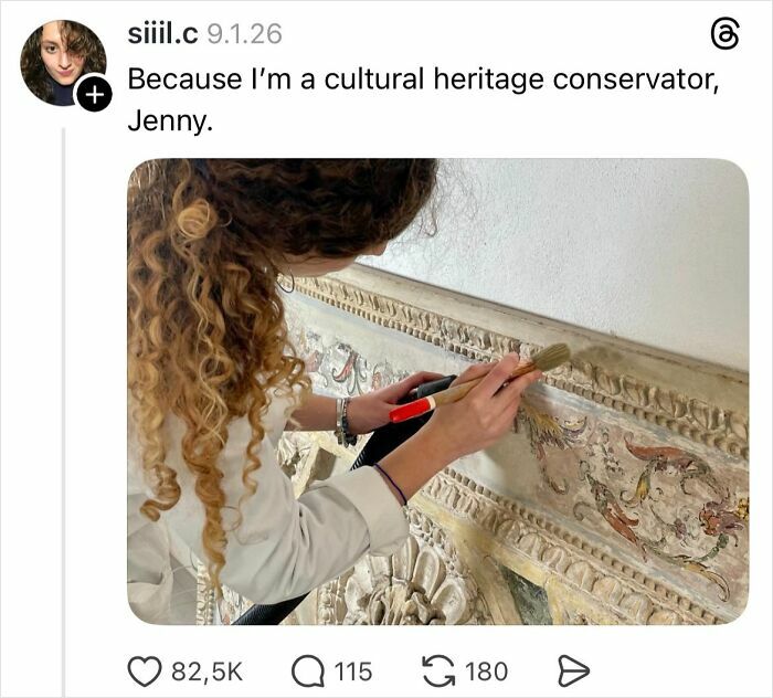 Woman with curly hair restoring ornate wall art, illustrating a cultural heritage conservator in action.