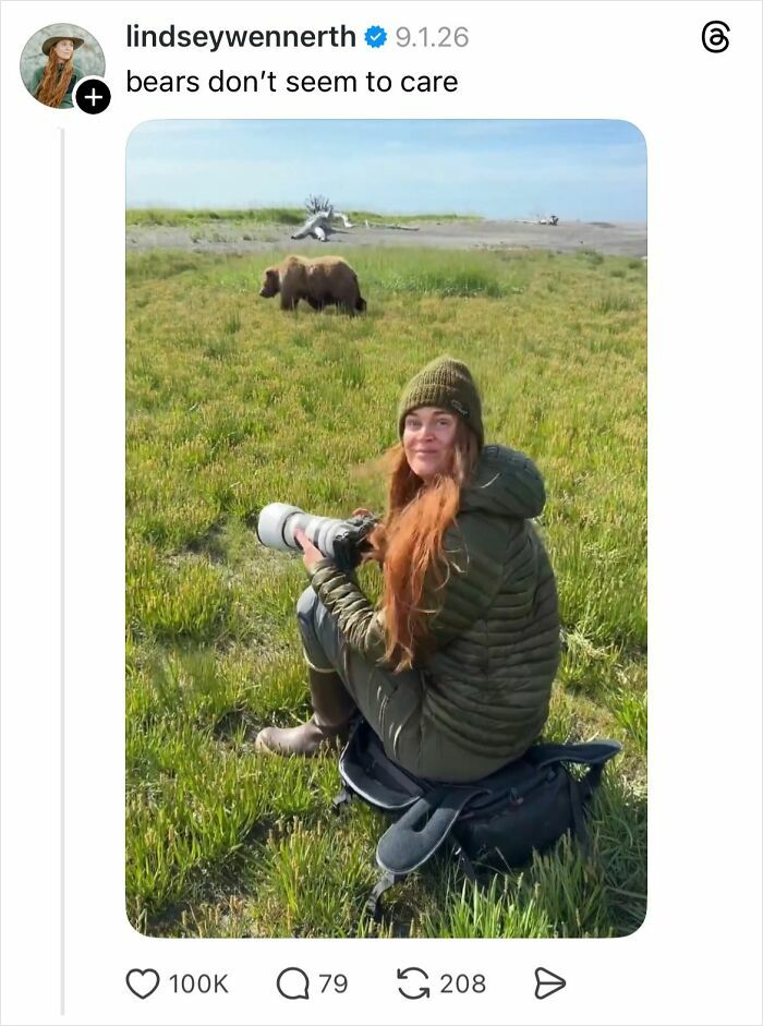 Woman outdoors with camera photographing bears in grassy field, illustrating why girls don’t get their nails done conversation.
