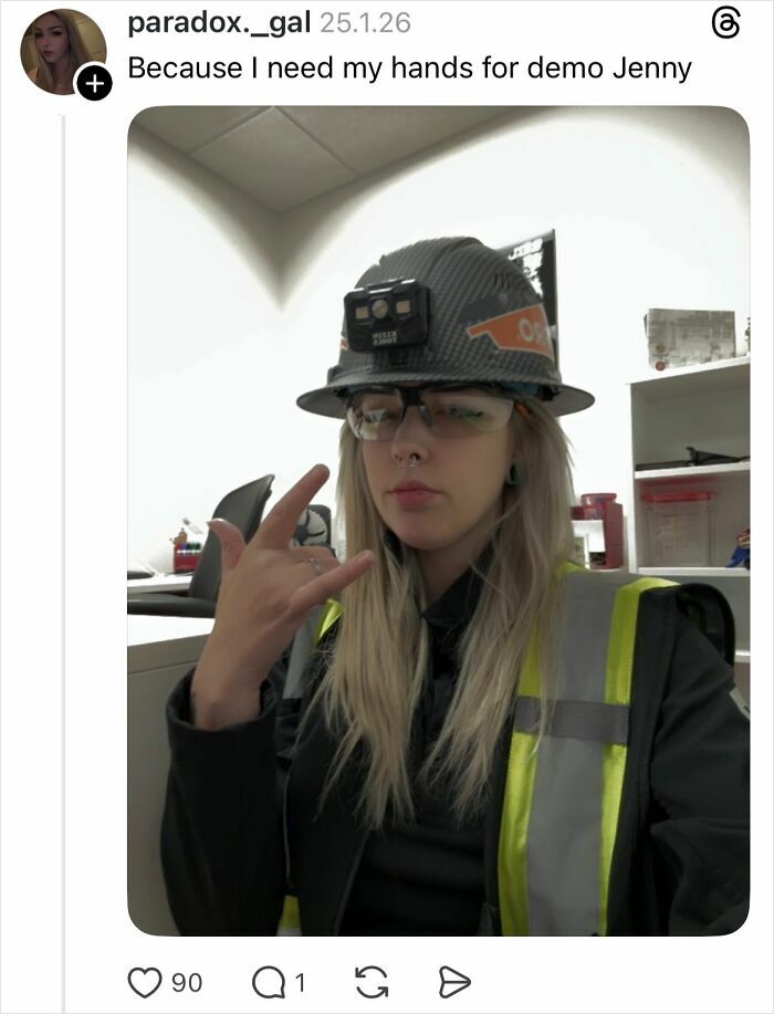 Woman in safety gear and glasses showing hand gesture, explaining why girls don’t get their nails done confidently.