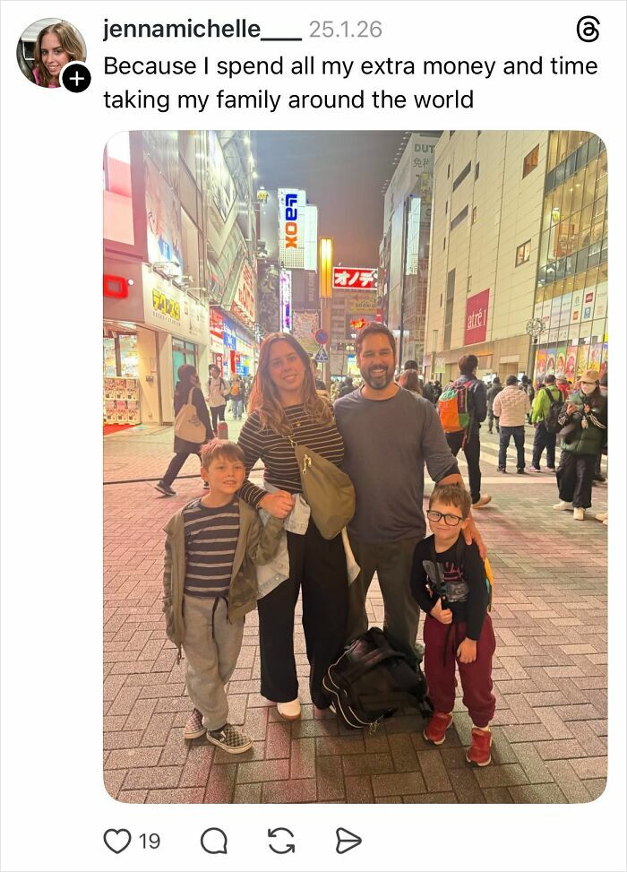 Family posing on a busy city street at night, capturing a moment related to women and nails in a casual setting.