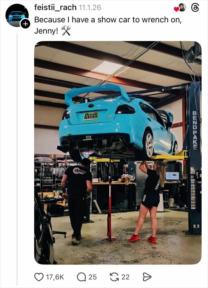 Woman working on show car in a garage, showcasing why girls don’t get their nails done with a hands-on approach.