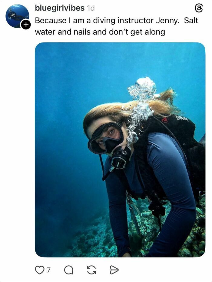 Woman scuba diving underwater with diving gear, explaining why girls don’t get their nails done.