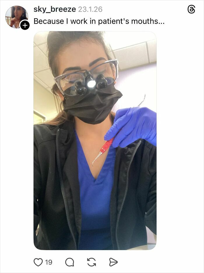 Woman in medical scrubs and mask holding dental tool, explaining why girls don’t get their nails done.