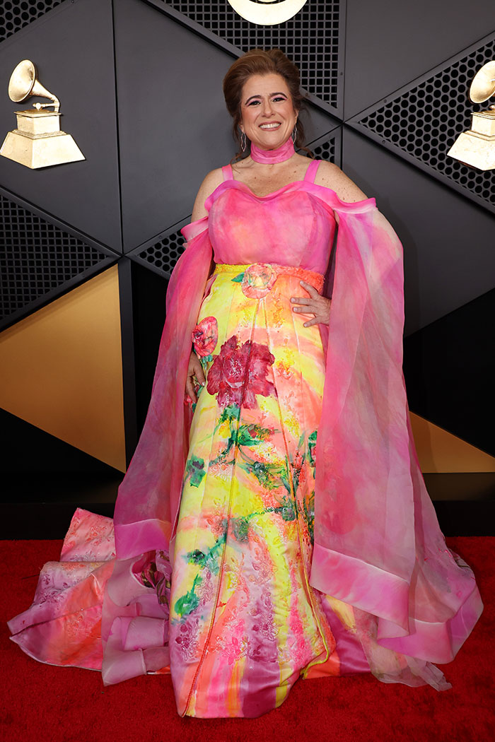 Woman in a pink and yellow floral gown posing on the red carpet showcasing 2026 Grammys fashion fails style.