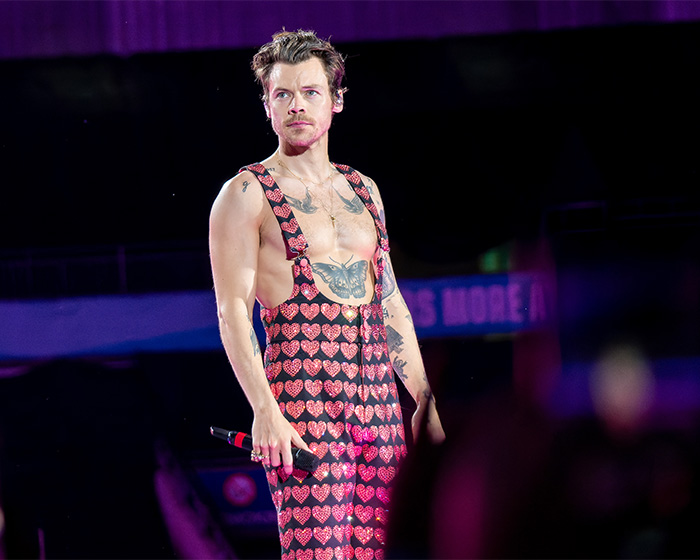 Harry Styles on stage wearing heart-patterned outfit during Grammys performance, sparking outfit criticism. Harry Styles on stage wearing heart-patterned outfit during Grammys performance, sparking outfit criticism.