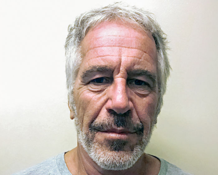 Jeffrey Epstein in a close-up portrait with gray hair and beard against a plain background.