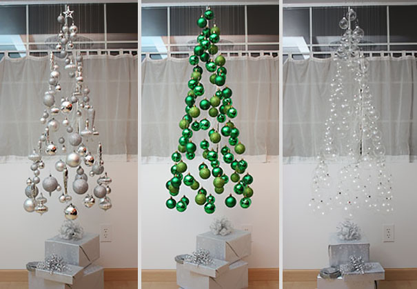 Hanging Christmas trees crafted from ornaments in silver, green, and white, showcasing creative DIY design ideas.