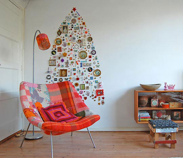 Creative DIY Christmas tree made from wall ornaments beside a colorful chair in a cozy room.