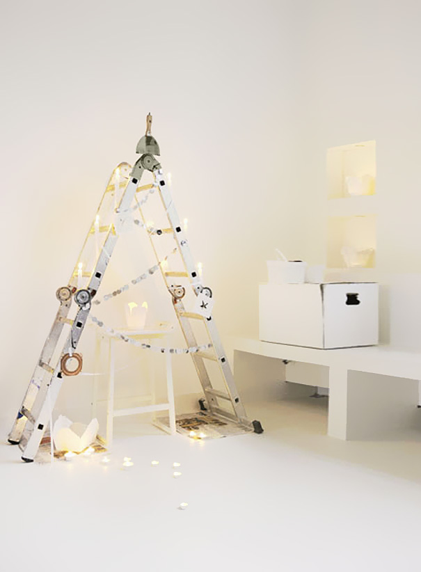 DIY Christmas tree made from a white ladder, decorated with lights and garlands, creating a minimalist holiday display. DIY Christmas tree made from a white ladder, decorated with lights and garlands, creating a minimalist holiday display.