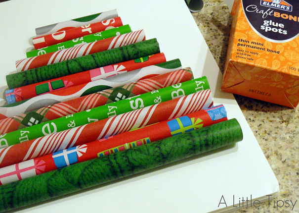 DIY Christmas tree made from colorful wrapped paper rolls with glue spots on a countertop.