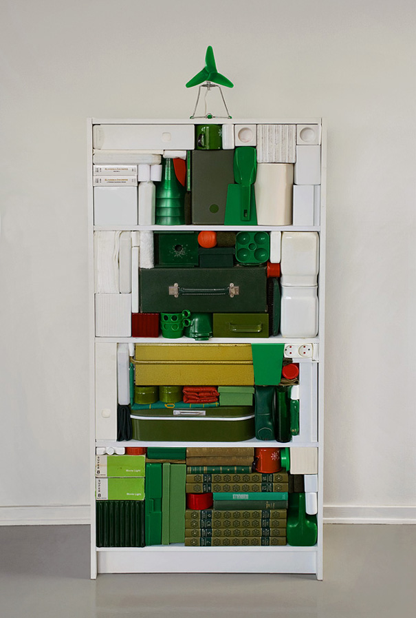 Creative DIY Christmas tree made from stacked green and white items on shelves, with a toy airplane on top. Creative DIY Christmas tree made from stacked green and white items on shelves, with a toy airplane on top.