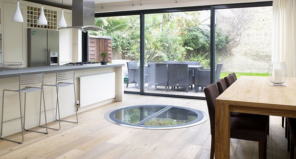 Modern open kitchen and dining area with glass floor feature and large sliding doors overlooking garden design ideas for your house. Modern open kitchen and dining area with glass floor feature and large sliding doors overlooking garden design ideas for your house.