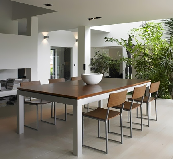 Modern dining area with wooden table and chairs surrounded by greenery, showcasing amazing design ideas for your house. Modern dining area with wooden table and chairs surrounded by greenery, showcasing amazing design ideas for your house.