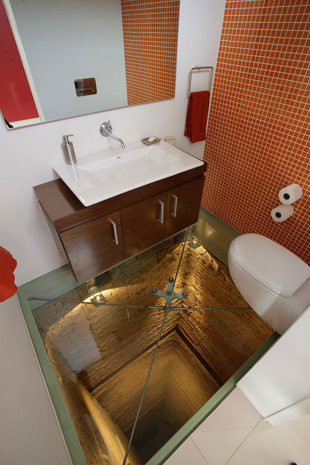 Modern bathroom with glass floor revealing brick shaft below featuring amazing design ideas for your house interior. Modern bathroom with glass floor revealing brick shaft below featuring amazing design ideas for your house interior.