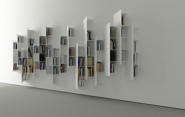 Creative bookshelf design with irregular, modern white shelves displaying various books on a minimalist wall. Creative bookshelf design with irregular, modern white shelves displaying various books on a minimalist wall.