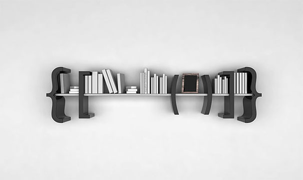 Creative bookshelf design resembling curly brackets with books and a small frame. Creative bookshelf design resembling curly brackets with books and a small frame.