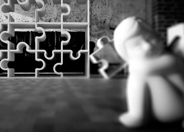 Creative bookshelf design with puzzle-shaped shelves, accompanied by a blurred statue in the foreground.