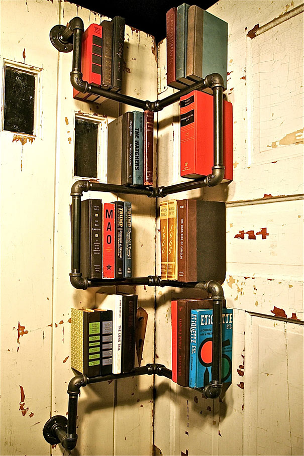 Creative bookshelf design using industrial pipes on a rustic door background. Creative bookshelf design using industrial pipes on a rustic door background.