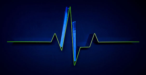 Heartbeat-themed creative bookshelf design on a dark wall.