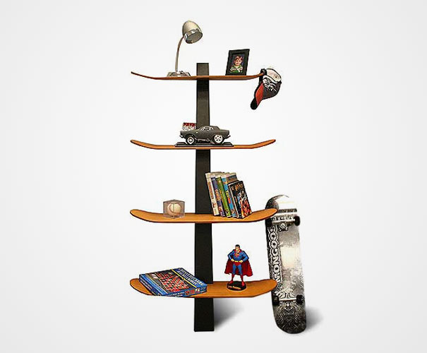Creative bookshelf design using skateboards as shelves with various items displayed.