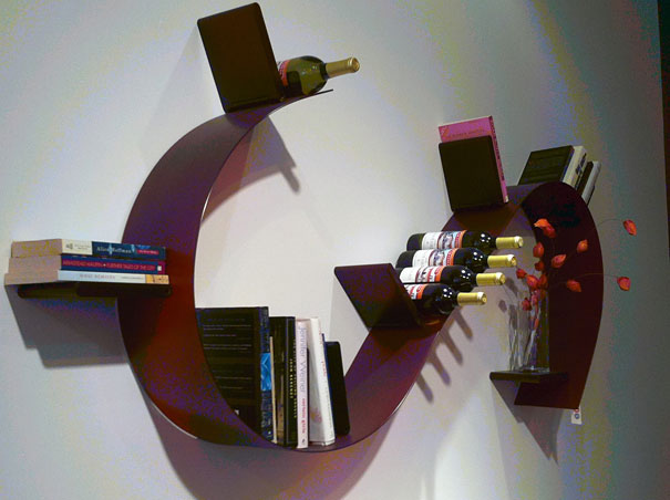 Creative bookshelf design with curved shape, holding books, wine bottles, and a vase.
