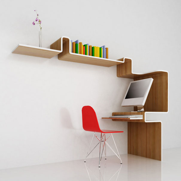 Creative bookshelf design with integrated workspace, featuring colorful books, a computer, and a red chair.