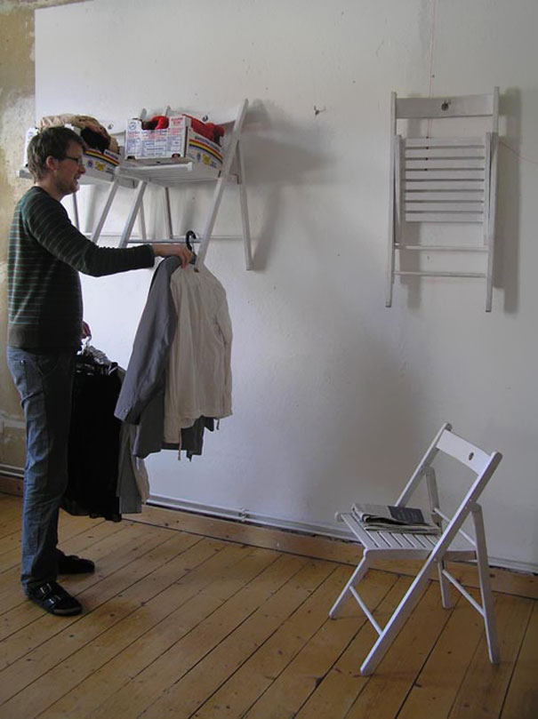 Person hanging clothes on hangers