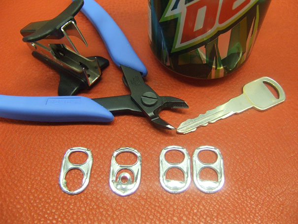 Can, pop tabs and scissors with key