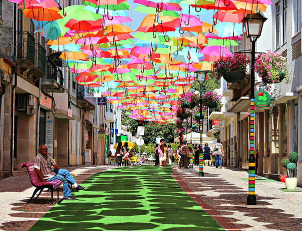 Hundreds of Floating Umbrellas Above a Street in Agueda, Portugal Hundreds of Floating Umbrellas Above a Street in Agueda, Portugal
