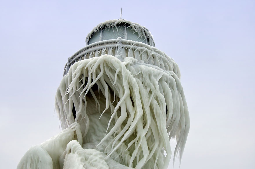 Frozen Lighthouses Caught In Winter's Icy Grip On Lake Michigan Shore