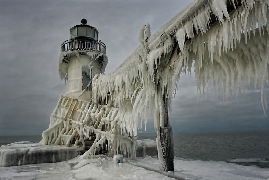 Frozen Lighthouses Caught In Winter's Icy Grip On Lake Michigan Shore