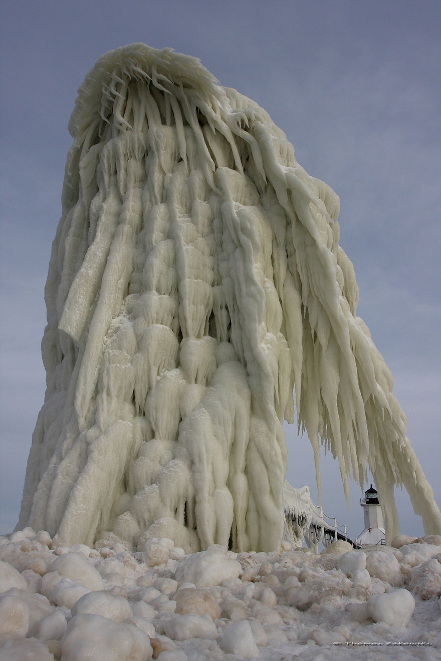 Frozen Lighthouses Caught In Winter's Icy Grip On Lake Michigan Shore