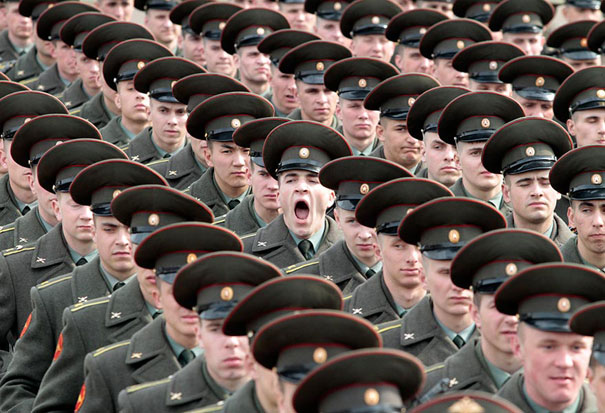Perfectly timed photo of soldiers in uniform, with one soldier yawning among the ranks, capturing a candid moment.
