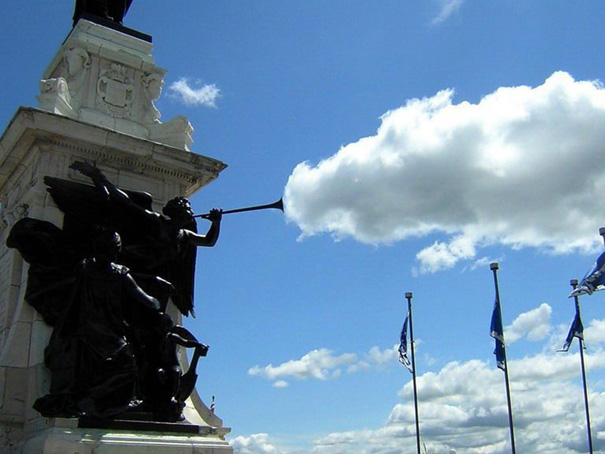 Perfectly timed photo of a statue appearing to blow a trumpet-shaped cloud against a blue sky. Perfectly timed photo of a statue appearing to blow a trumpet-shaped cloud against a blue sky.