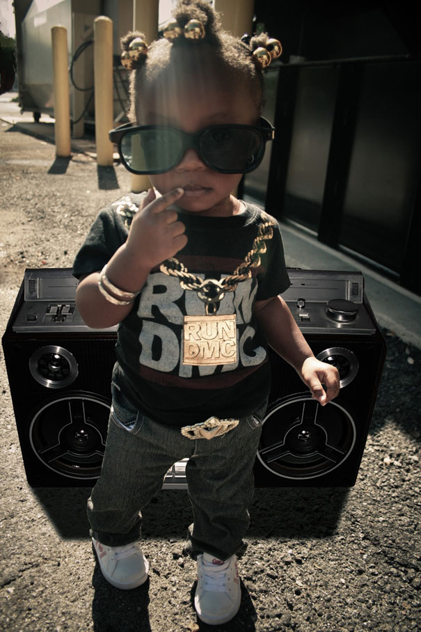 Kid in a RUN DMC costume with sunglasses, gold chain, and a boombox, showcasing a best kids' Halloween costume. Kid in a RUN DMC costume with sunglasses, gold chain, and a boombox, showcasing a best kids' Halloween costume.