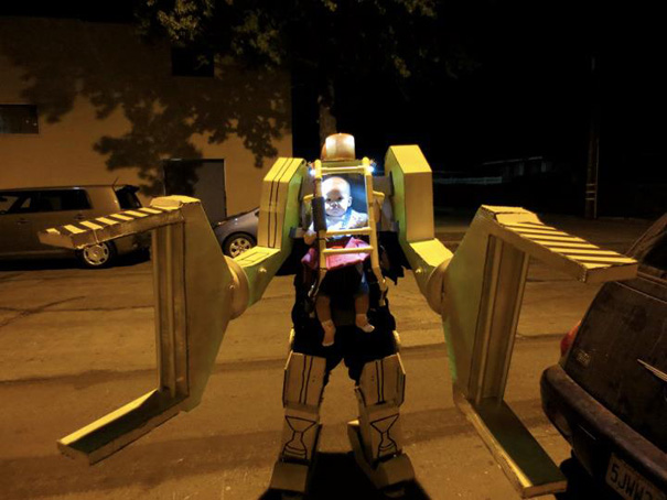 Child in a creative robot Halloween costume with mechanical arms at night. Child in a creative robot Halloween costume with mechanical arms at night.