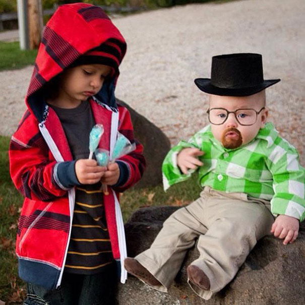 Two kids in creative Halloween costumes; one in a red hoodie, the other with glasses and a hat, dressed humorously. Two kids in creative Halloween costumes; one in a red hoodie, the other with glasses and a hat, dressed humorously.