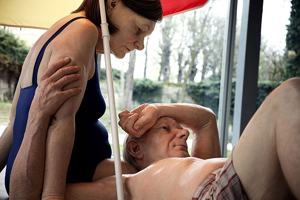 Hyper-realistic artwork of an elderly couple under a beach umbrella, capturing lifelike skin textures and expressions. Hyper-realistic artwork of an elderly couple under a beach umbrella, capturing lifelike skin textures and expressions.