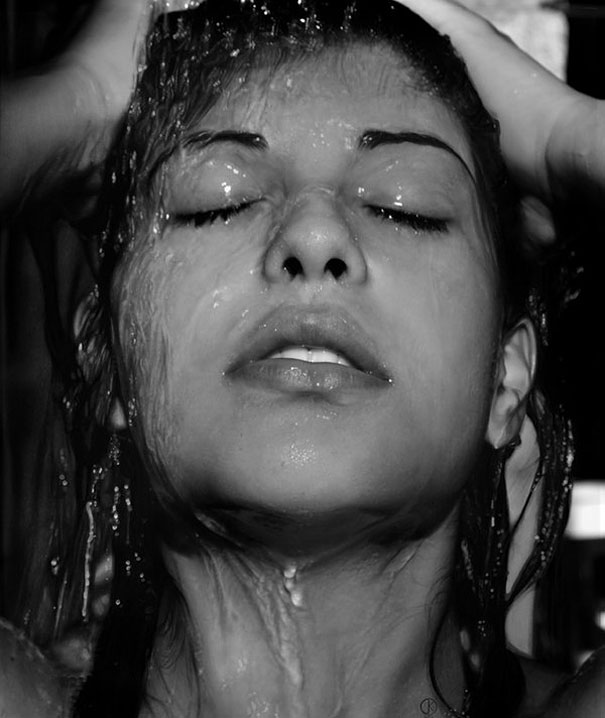 Hyper-realistic artwork of a woman's face with water droplets, capturing lifelike detail and texture. Hyper-realistic artwork of a woman's face with water droplets, capturing lifelike detail and texture.