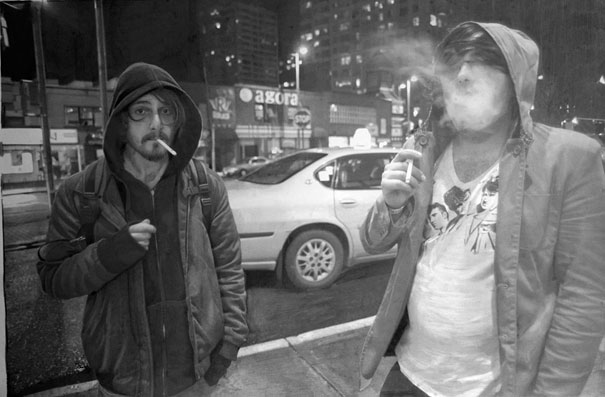 Two individuals smoking on a city street at night, depicted in a hyper-realistic artwork. Two individuals smoking on a city street at night, depicted in a hyper-realistic artwork.