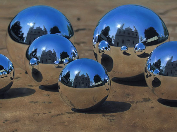 Hyper-realistic artwork of reflective spheres on a surface, with building reflections creating an illusion of photography.