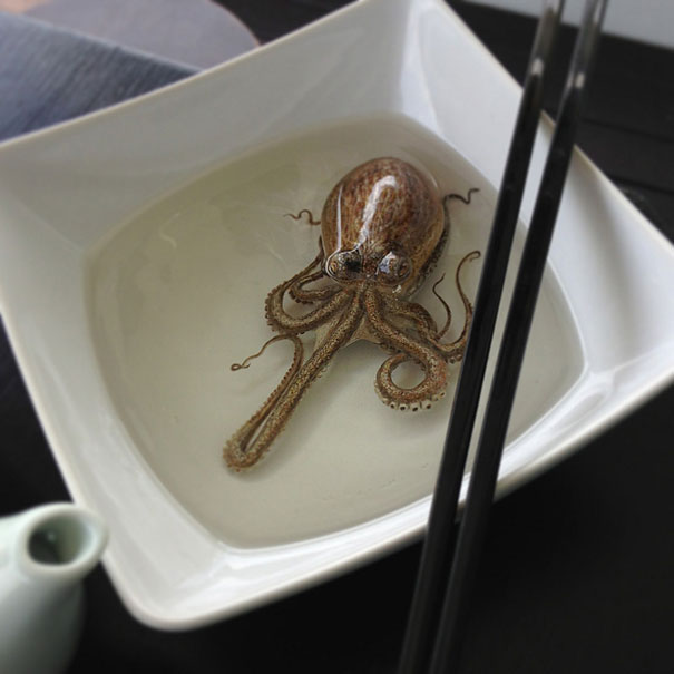 Hyper-realistic artwork of an octopus in a white dish, resembling a photo, with black chopsticks on the side. Hyper-realistic artwork of an octopus in a white dish, resembling a photo, with black chopsticks on the side.
