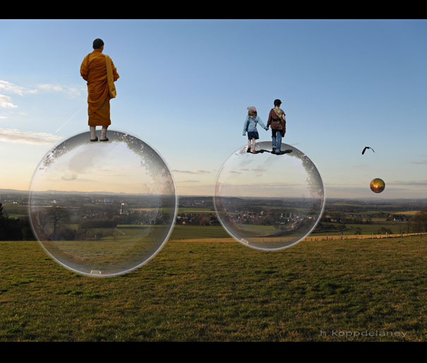 A monk and two children standing on large transparent bubbles over a grassy field, symbolizing dreams.